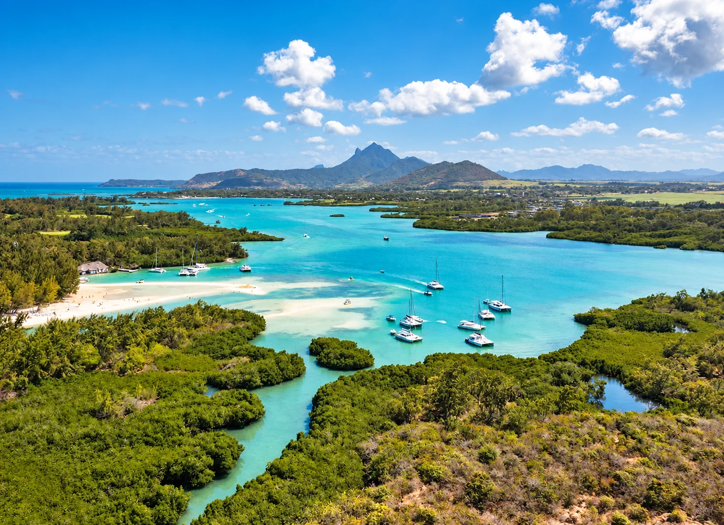 Aerial view of Île aux Cerfs, its lagoon and the east-coast mountains of Mauritius