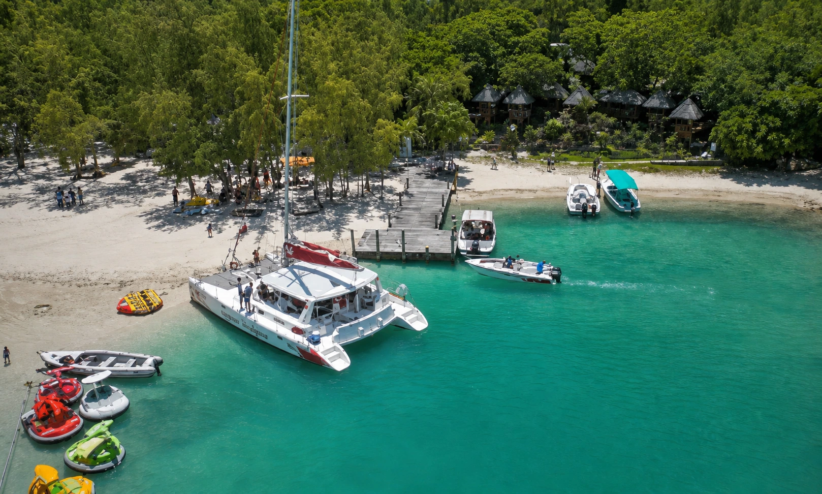 Catamaran beside an east-coast beach and turquoise lagoon